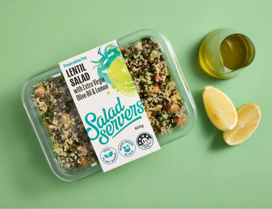 Salad Servers Lentil Salad tub beside olive oil and fresh lemon