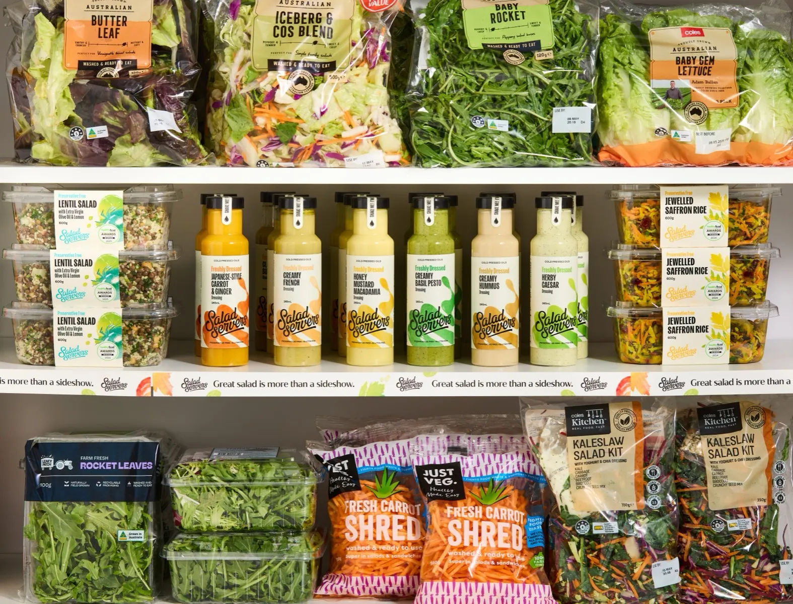 The Freshly Dressed range on a supermarket shelf in the fresh section, between bagged leaf salads